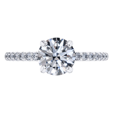 Elegant 4 Claw Platinum Round Brilliant Engagement Ring with Diamond Sides .